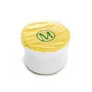 Photo montrant la recharge de la Crème Ginkgo Sacré sur fond blanc avec son opercule aluminium doré frappé du monogramme de Mastel
